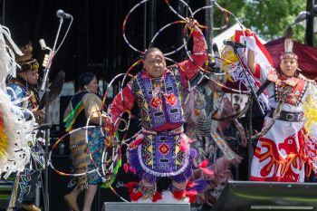 Indigenous hoop dancer and other dancers