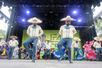 Group of dancers perform on stage