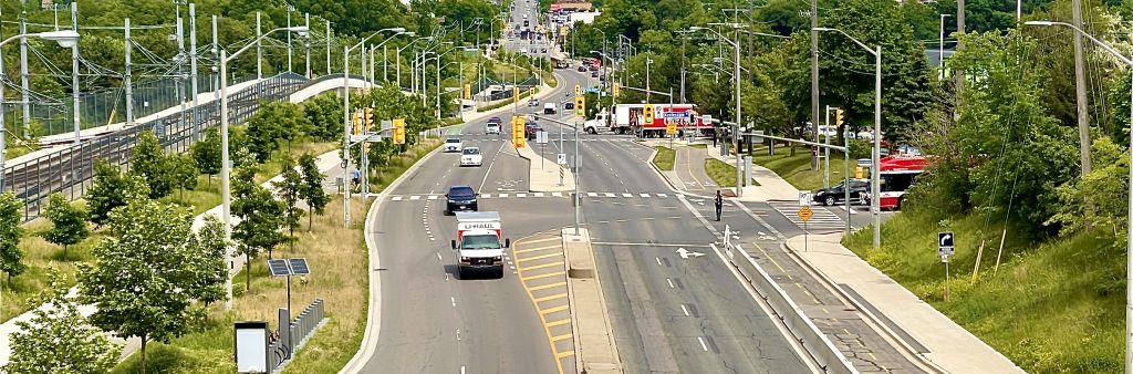 Image of Keelesdale Road and Eglinton Avenue West of cars, bike lanes and the Eglinton LRT.