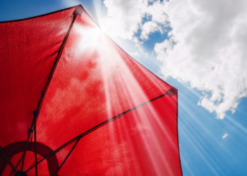 Red umbrella against a sunny sky.