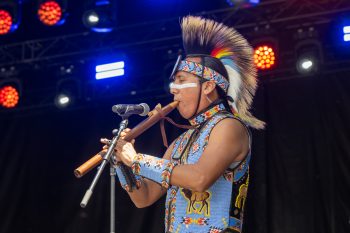 Indigenous musician plays woodwind instrument