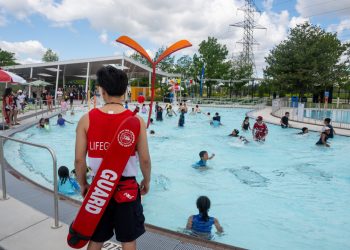 Lifeguard looking out at pool.