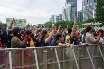 Audience cheering behind barricade