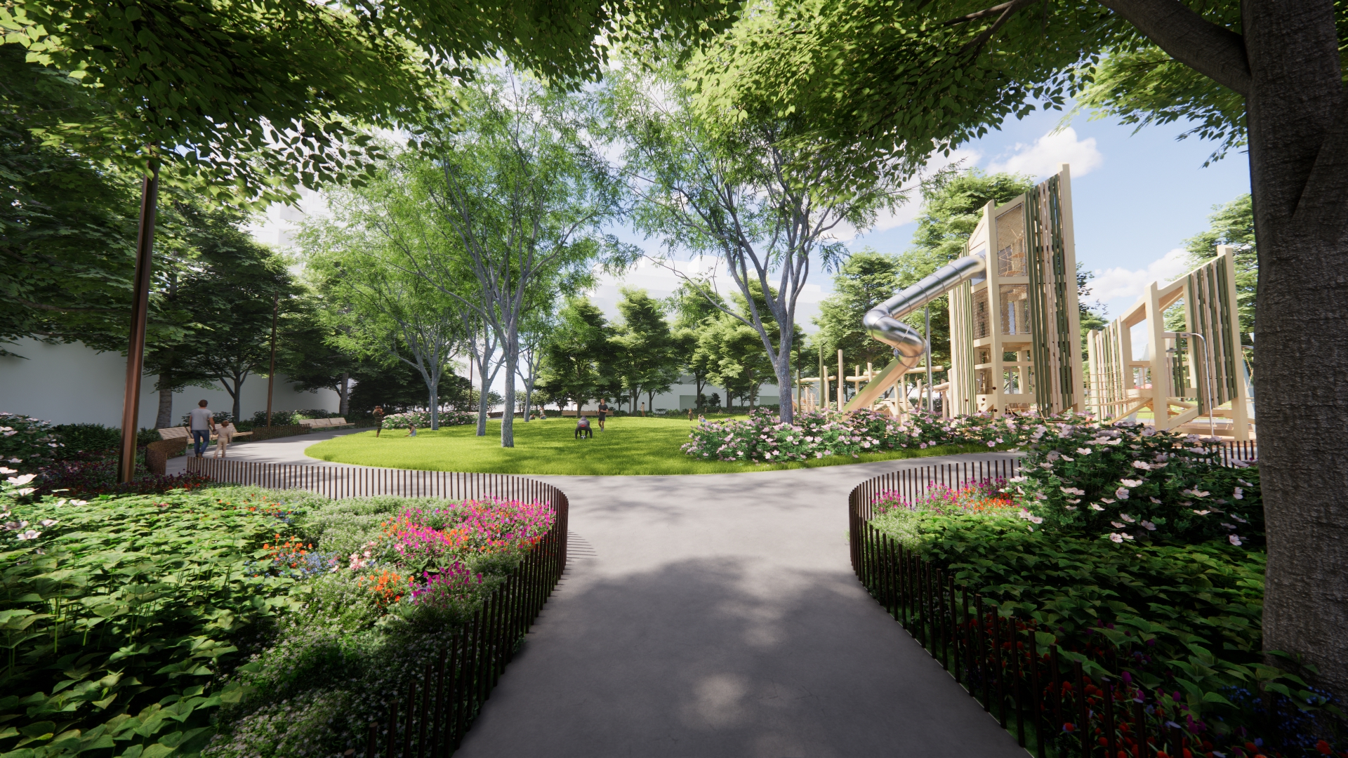 View from the Mathersfield Drive entrance. An open lawn is framed by a path and lush planting beds with seasonal flowering accents and mature trees, creating a welcoming park setting. To the right, two wooden play towers are connected by play elements and feature a stainless-steel tube slide.