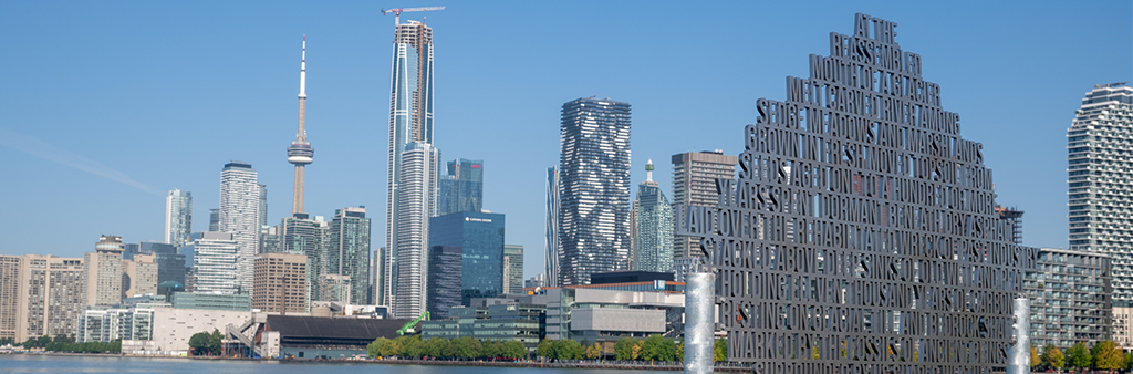 A metal sculpture feature words and phrases overlooking Toronto's inner Harbour
