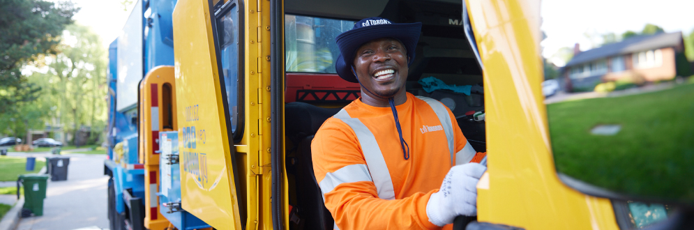 A City of Toronto worker operating a collection truck