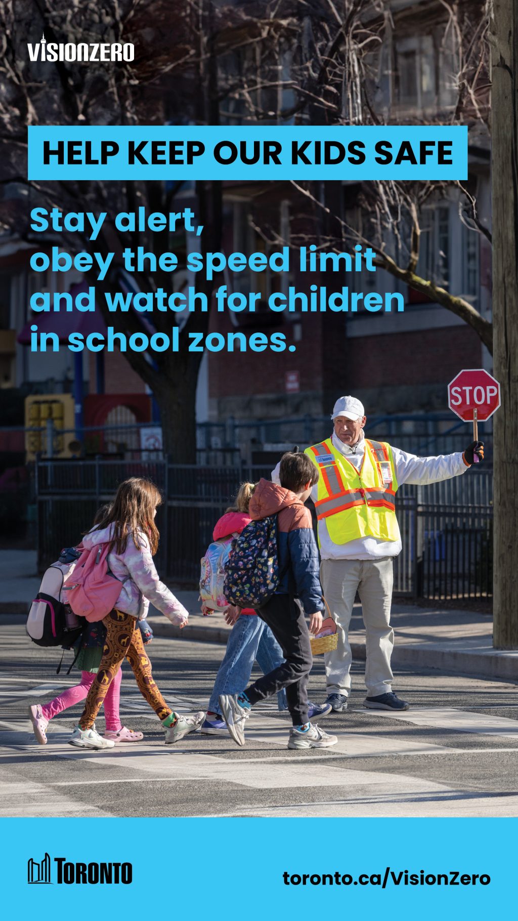 Image of children crossing the road with the help of a school crossing guard. 