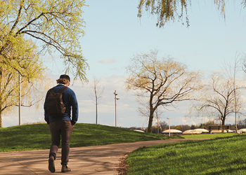 A person walking on a paved path