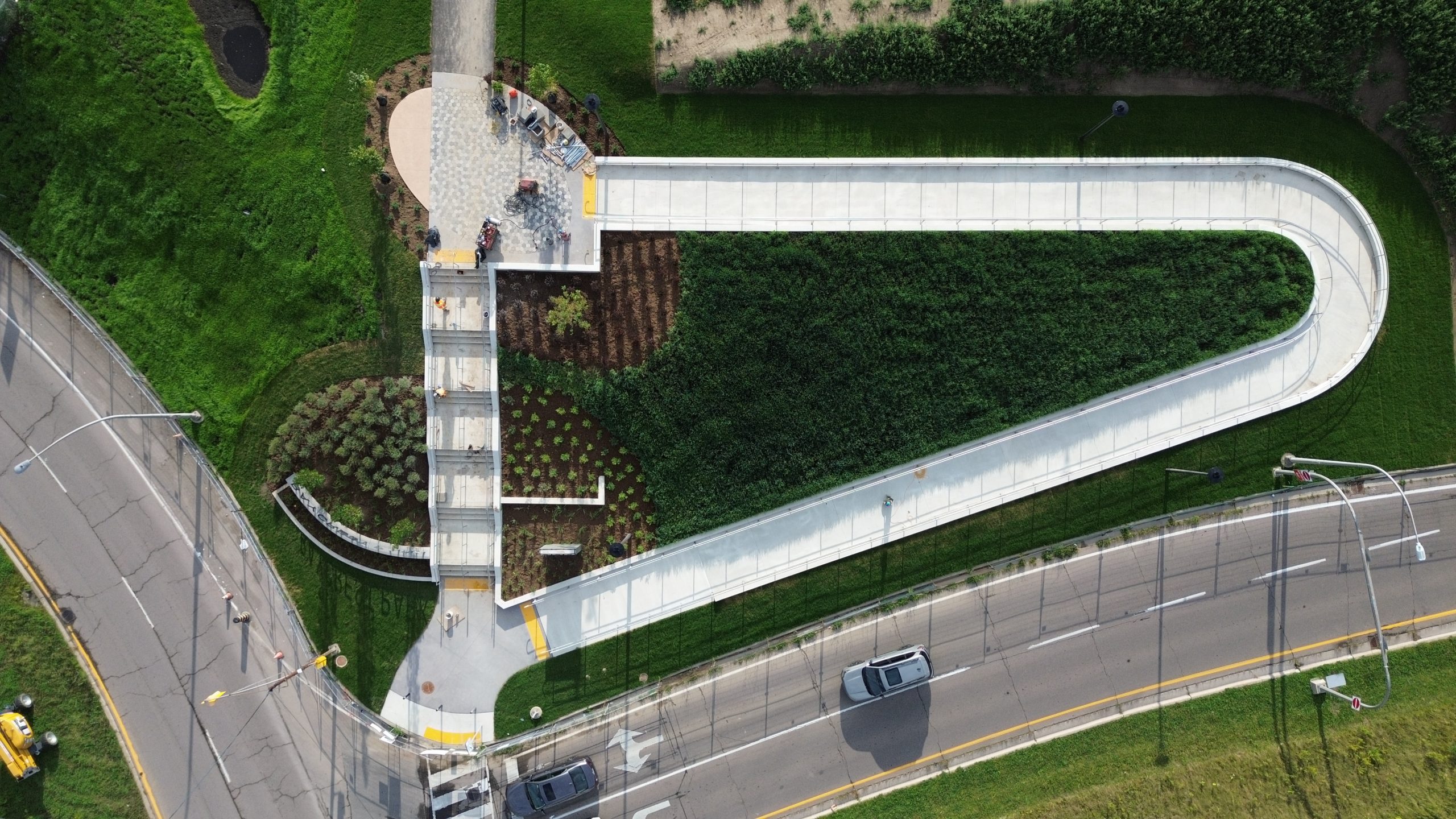 Aerial view of the ramp and stairs in Baycrest Park, surrounded by open grass lawns.