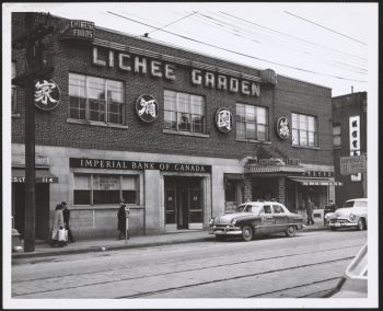 Image depicts monochrome photograph of restaurant exterior