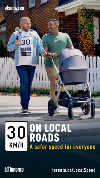 Vision Zero campaign ad promoting 30 km/h on local roads as a safer speed for everyone. Two men are walking while pushing a stroller. A "Maximum 30 Area Begins" road sign is overlaid on the shirt of one of the men.