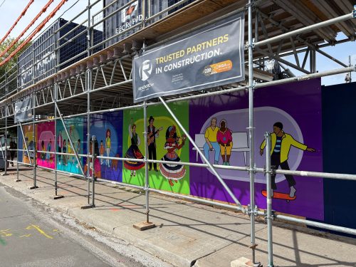 A colourful mural on construction hoarding.