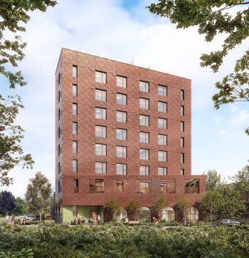 Eight storey building with brown brick façade surrounded by greenery.