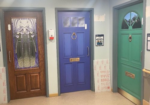 Seven Oaks door murals in brown, blue and green.