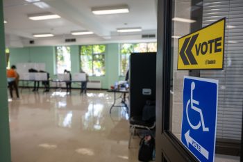 Directional voting signs at a polling location, including a sign for an accessible voting area.